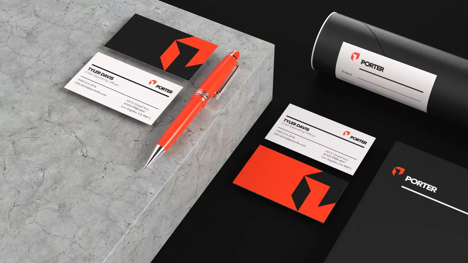 Porter business cards, pen, and mailing tube in black and red