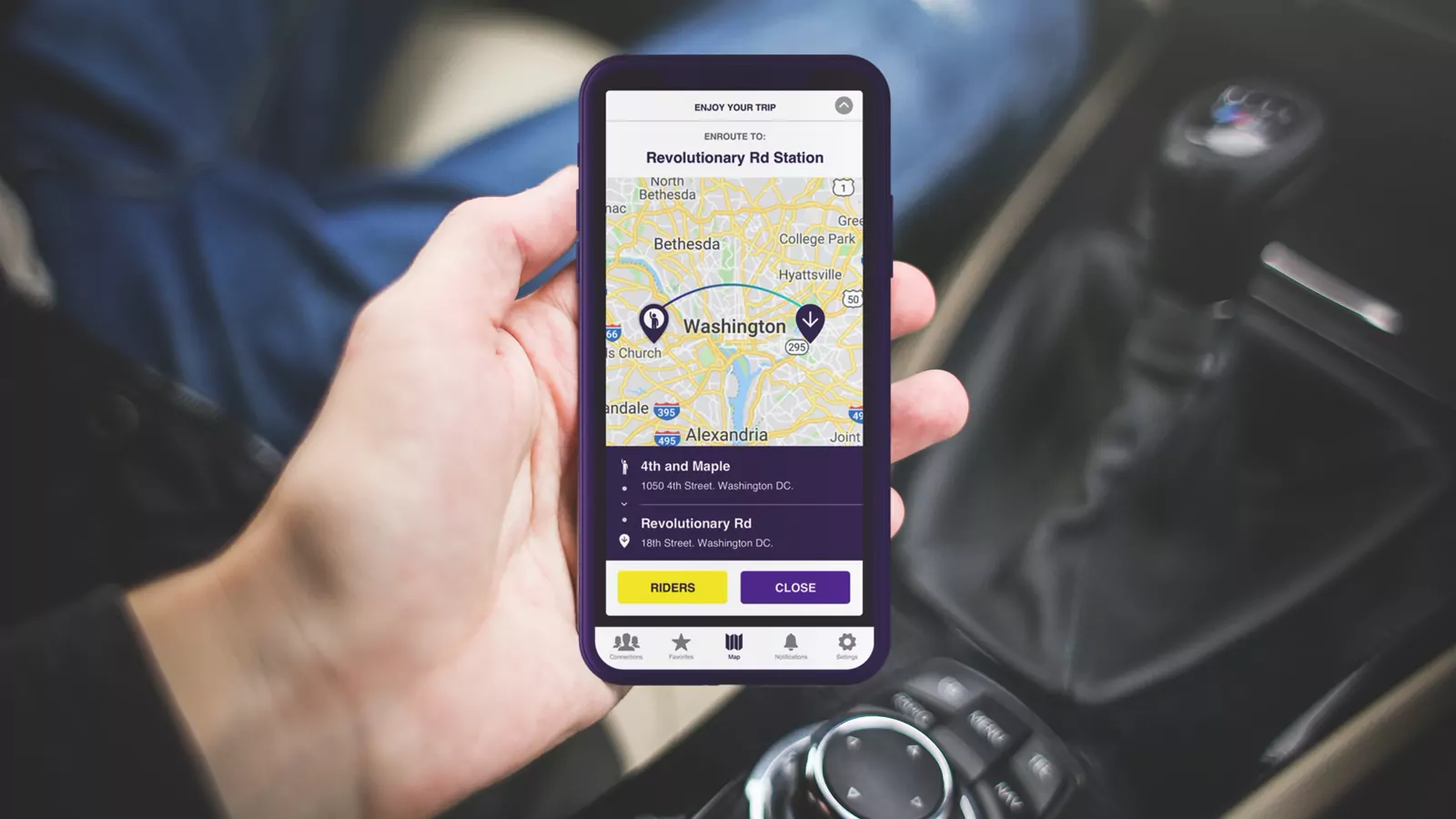 Otter carpool app on a phone in a car, showing a route across Washington, D.C.